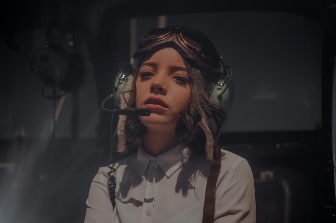 British female broadcast engineer wearing a headset during a remote production shoot