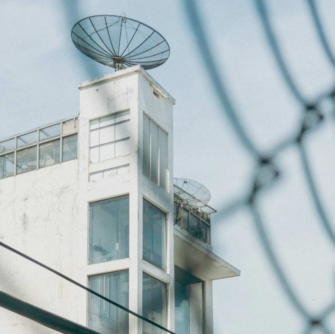 Satellite uplink dish against a clear sky used for live broadcast transmission